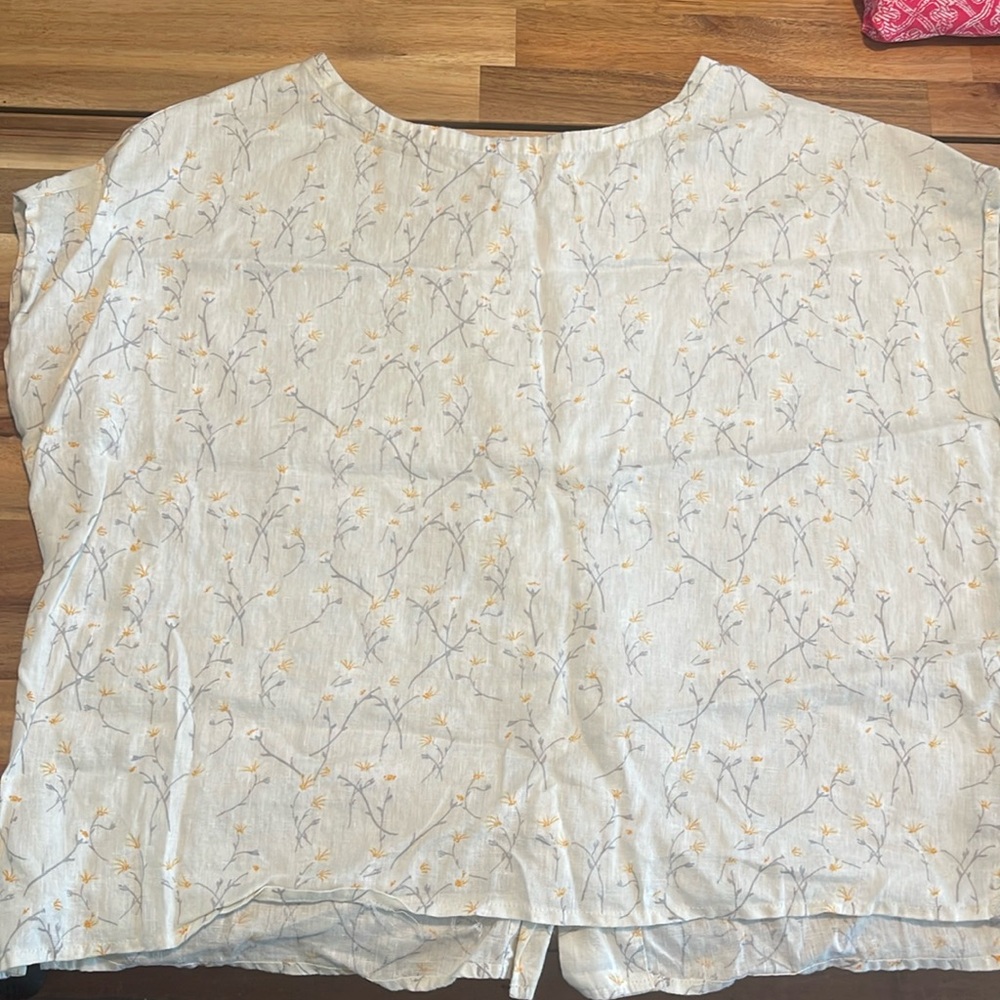 Linen top with flower print and brown buttons on the back. Worn once